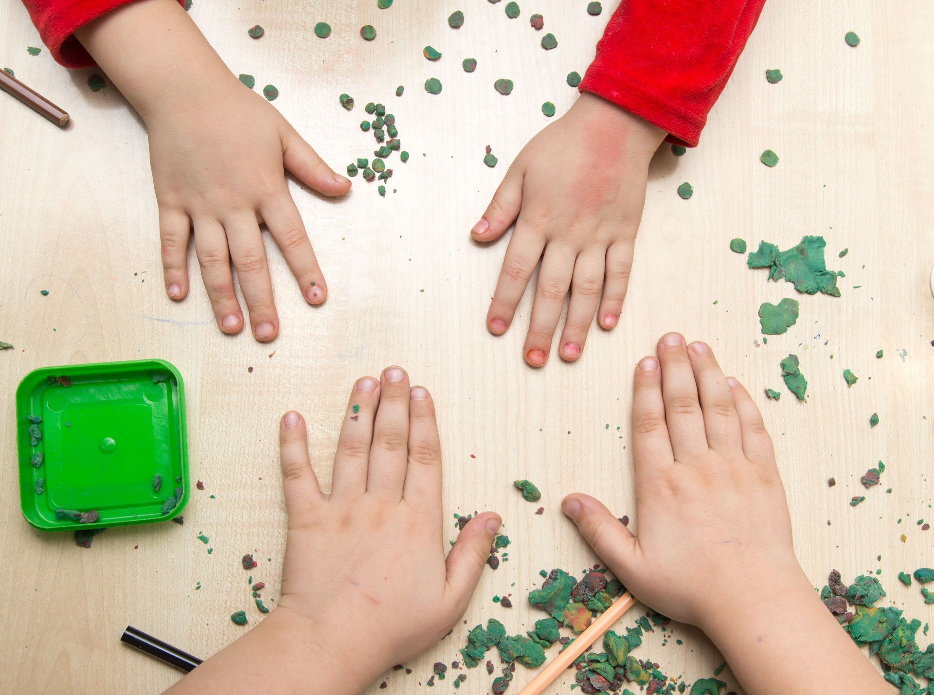 Boy and girl sculpts from plasticine on the table