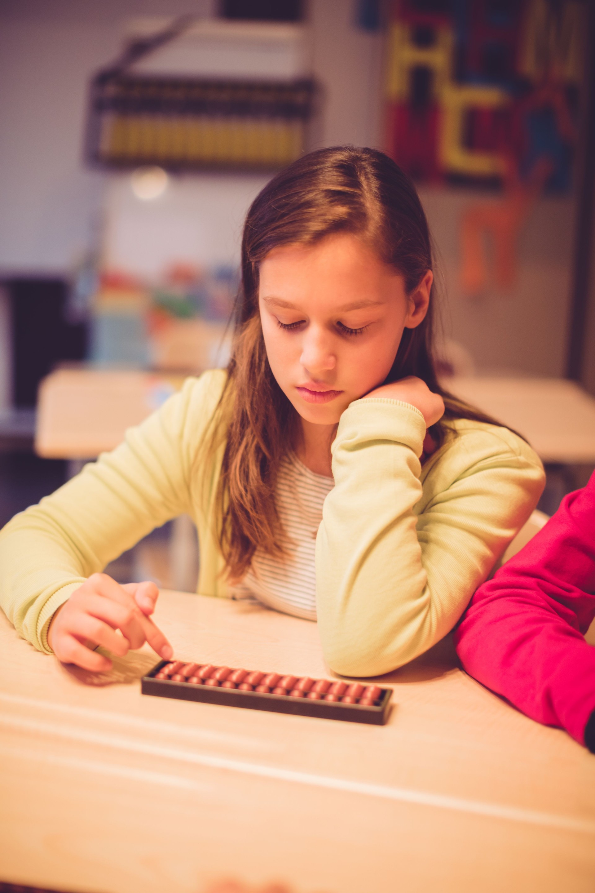 Teenage girl using abacus