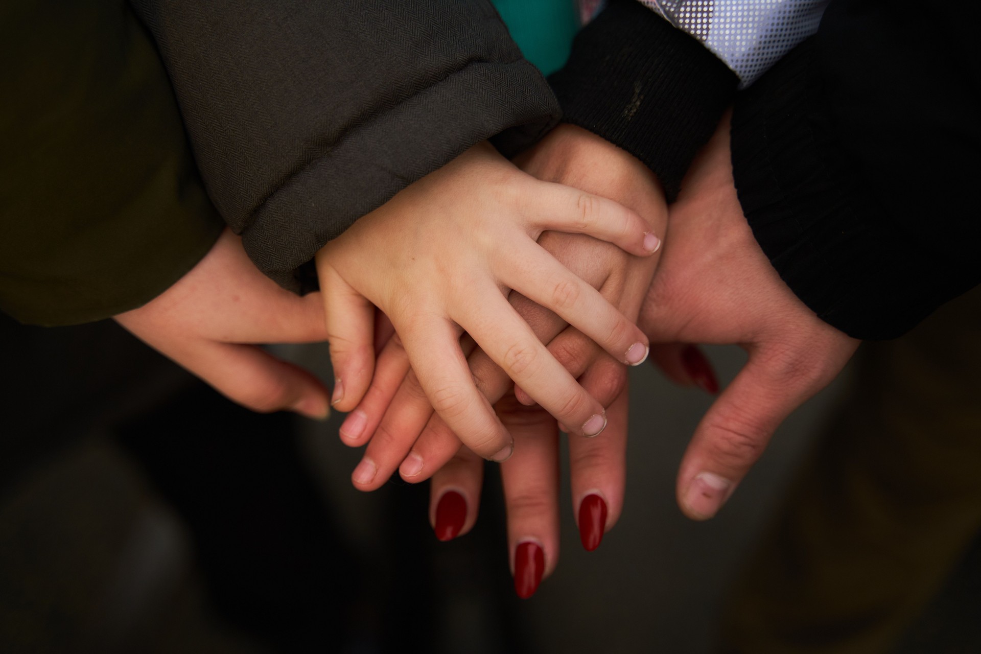 Human hands. The hands of adults and the child on top of each other. Close-up
